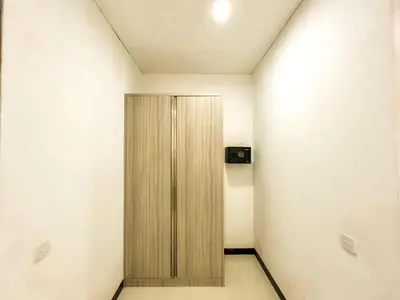 a room with a wooden cabinet in the corner at Ratu Deandra Villa Seminyak in Seminyak