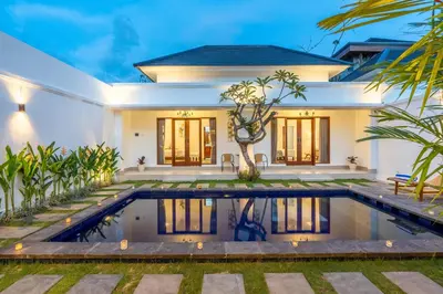 a villa with a swimming pool in front of a house at Mich Bali Villa Two-Bedroom Private Pool Kuta in Seminyak