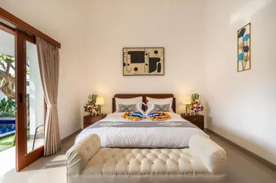 a bedroom with a white bed and a large window at Mich Bali Villa Two-Bedroom Private Pool Kuta in Seminyak