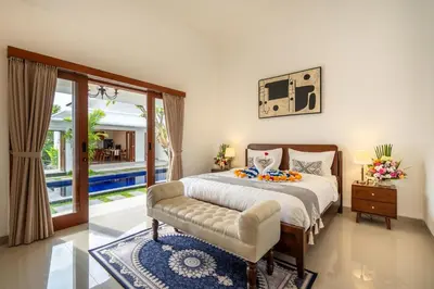 a bedroom with a bed and a sliding glass door at Mich Bali Villa Two-Bedroom Private Pool Kuta in Seminyak
