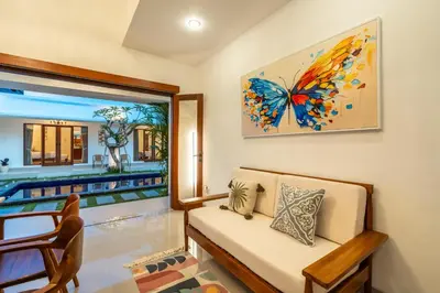 a living room with a butterfly painting on the wall at Mich Bali Villa Two-Bedroom Private Pool Kuta in Seminyak