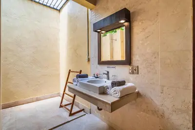 a bathroom with a sink and a mirror at Aileen 4 BR Private Pool Villa in Seminyak