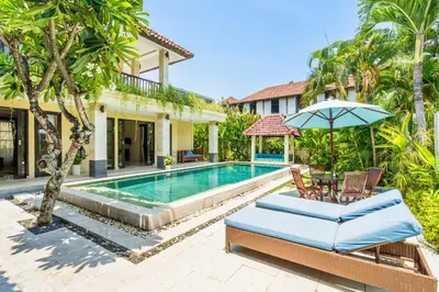a villa with a swimming pool and a house at Aileen 4 BR Private Pool Villa in Seminyak