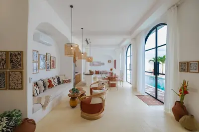 a living room with a couch and a table at Ocean View 4BR Design Villa with Lap Pool & Rooftop Jacuzzi in Jimbaran