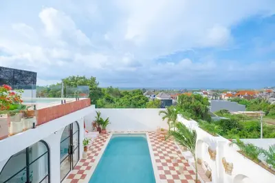 a swimming pool on the side of a building at Ocean View 4BR Design Villa with Lap Pool & Rooftop Jacuzzi in Jimbaran