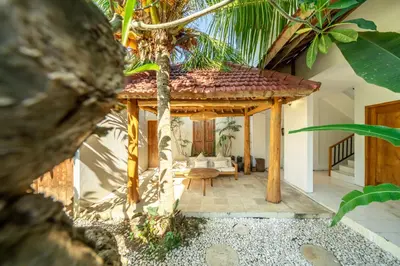 a living room with a gazebo and palm trees at Tuluscoliving Villa Legian 4 Bedrooms and 4 Bathroom in Legian