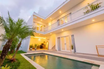 a house with a swimming pool in front of it at Anatari 3 BR Private Pool Villa in Seminyak