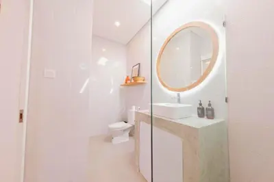 a white bathroom with a sink and a mirror at Anatari 3 BR Private Pool Villa in Seminyak