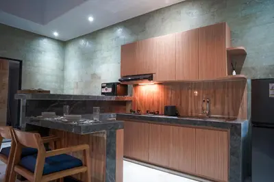 a kitchen with a counter with a sink and a stove at Villa Maharani Sanur in Sanur