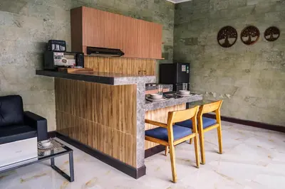a bar in a room with a table and chairs at Villa Maharani Sanur in Sanur