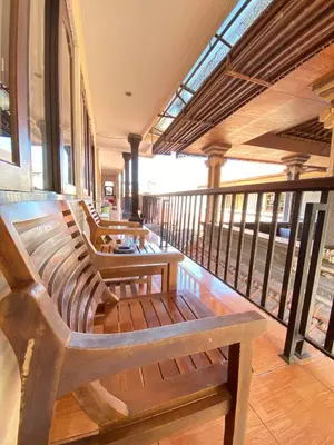 two benches sitting on a balcony of a building at ABI Hotel3 - 1 minute to the Beach and 1 second to the Mall in Ngurah Rai International Airport