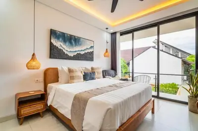 a bedroom with a large bed and a large window at Bimala 3 BR Private Pool Villa in Seminyak