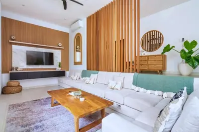 a living room with a white couch and a table at Bimala 3 BR Private Pool Villa in Seminyak