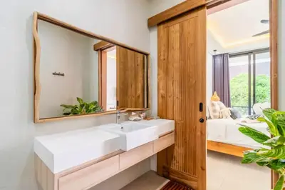 a bathroom with a white sink and a mirror at Bimala 3 BR Private Pool Villa in Seminyak
