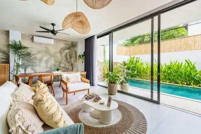 a living room with a couch and a table at Bimala 3 BR Private Pool Villa in Seminyak