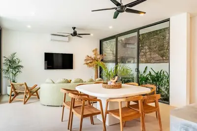 a living room with a table and chairs at Tropical Chic Villa w Rooftop & Pool in Seminyak in Seminyak