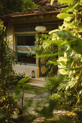 a front door of a house with a window at Magia de Uma, a Member of Design Hotels in Canggu