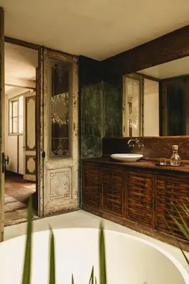 a bathroom with a tub and a sink at Magia de Uma, a Member of Design Hotels in Canggu