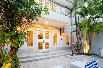 a front door of a house with palm trees at D Villa Seminyak in Seminyak