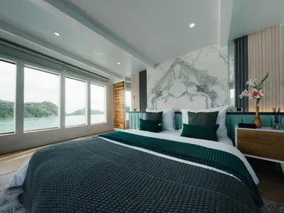 a bedroom with a large bed and a large window at Boat Komodo in Seminyak