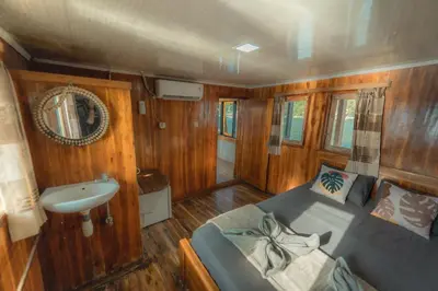 a small room with a bed and a sink at Boat Komodo in Seminyak