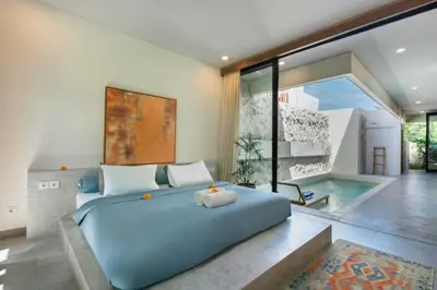 a bedroom with a large blue bed and a swimming pool at Shankara 2 BR Private Pool Villa in Seminyak