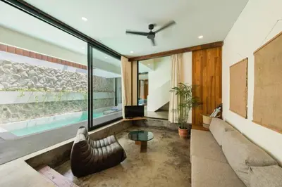 a living room with a couch and a table at Quilon 2 BR Private Pool Villa in Seminyak