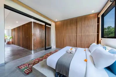 a bedroom with a large bed and a large window at Quilon 2 BR Private Pool Villa in Seminyak