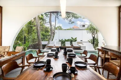 a long table in a room with a large window at Villa Lalalax 3BR Tropical Retreat in Jimbaran in Uluwatu