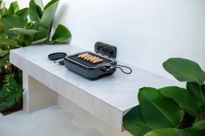 a grill sitting on a table next to some plants at Villa Lalalax 3BR Tropical Retreat in Jimbaran in Uluwatu