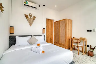 a bedroom with a white bed and a desk at FYM LOVE VILLA Residence BALI in Kerobokan