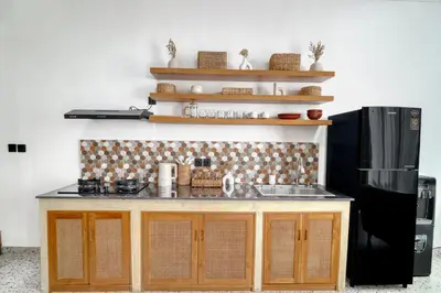 a kitchen with a counter and a refrigerator at FYM LOVE VILLA Residence BALI in Kerobokan