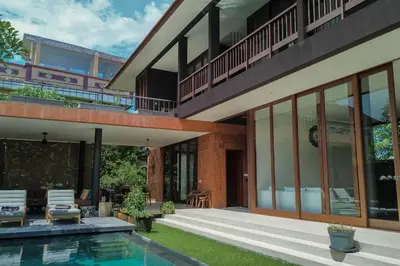 an external view of a house with a swimming pool at Bali Radiance 4 bedrooms with private bathrooms - Pool, Beach & Airport in Ngurah Rai International Airport