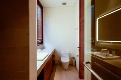 a bathroom with a toilet and two sinks and a mirror at Bali Radiance 4 bedrooms with private bathrooms - Pool, Beach & Airport in Ngurah Rai International Airport