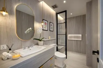 a bathroom with a sink and a toilet and a mirror at Colonial House 4BR Villa With Ocean View in Berawa in Canggu