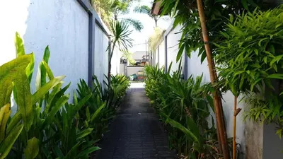 an alley way with plants and a building at Tahoma Villas Seminyak by ABM in Seminyak