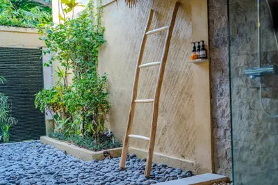 a wooden ladder leaning against a wall at Villa Evelyne, Luxury Villa, Fully Staffed, Central Seminyak in Seminyak