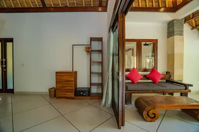 a room with a bed with red pillows and a mirror at Villa Evelyne, Luxury Villa, Fully Staffed, Central Seminyak in Seminyak