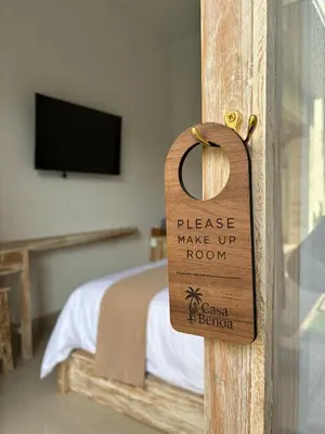 a wooden door sign that reads please make up room at Casa Benoa Homestay in Nusa Dua