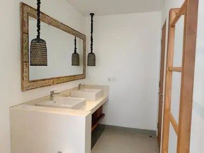 a bathroom with two sinks and a mirror at Tropikal villa 2 bedrooms in seminyak Bali in Seminyak