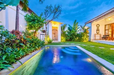 a swimming pool in front of a house at Avery 1 BR Private Pool Villa in Seminyak