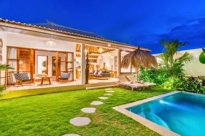 a backyard with a swimming pool and a villa at Avery 1 BR Private Pool Villa in Seminyak