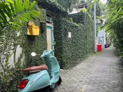 a scooter parked on the side of a building at Villa Odil, Great Value 700m beach & 15m pool in Seminyak