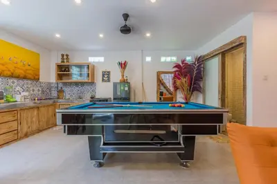 a kitchen with a pool table in a room at Villa Odil, Great Value 700m beach & 15m pool in Seminyak