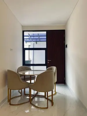 a dining room with a table and chairs and a window at Villa Bun Blessi in Pesanggaran