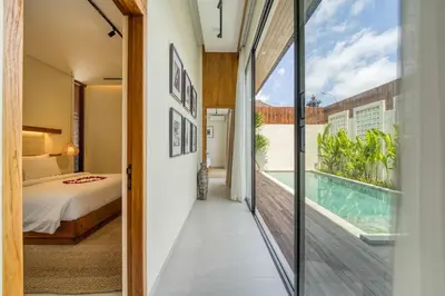 a room with a view of a pool and a bedroom at Tropical 3BR Villa 2 Private Pools in Jimbaran in Jimbaran