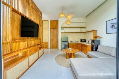 a living room with a couch and a tv at Tropical 3BR Villa 2 Private Pools in Jimbaran in Jimbaran