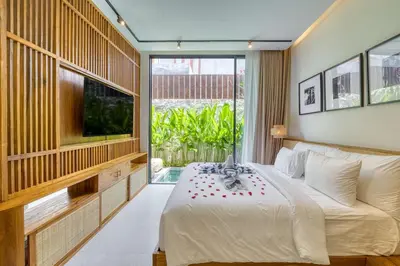 a bedroom with a large bed and a large window at Tropical 3BR Villa 2 Private Pools in Jimbaran in Jimbaran