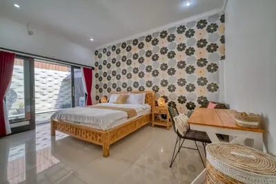a bedroom with a bed and a table and a desk at Rumah Bella Private Villa 3 Bedroom 3 Bathroom in Jimbaran