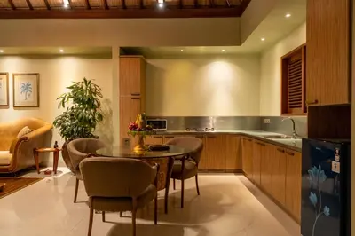 a kitchen with a table and chairs and a dining room at Villa Elegant by Exotiq in Seminyak